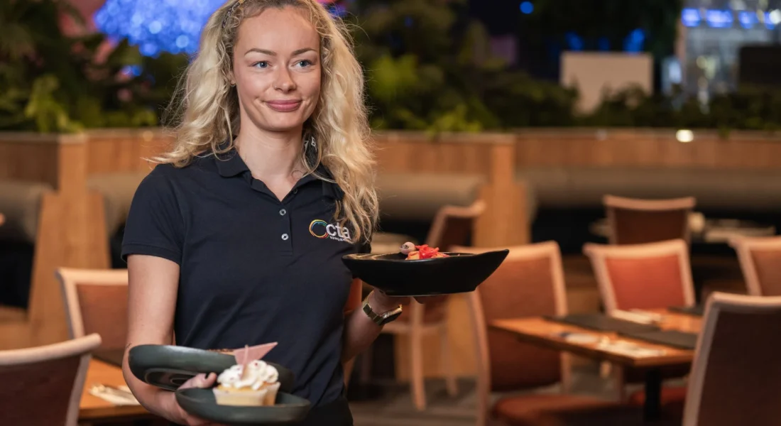 A waiter carries three dishes.