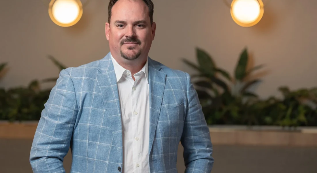 A professional person in a white shirt and blue blazer