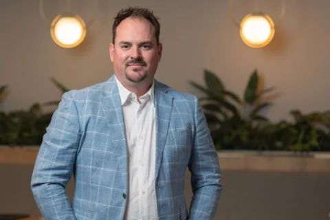 A professional person in a white shirt and blue blazer