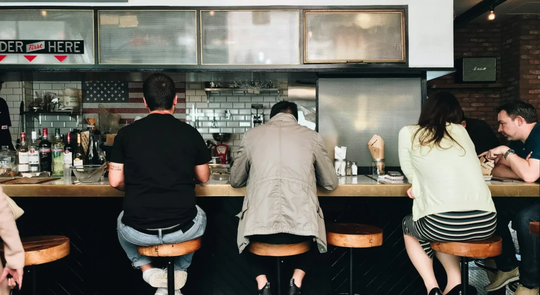 People sit at the bar for a burger restaurant