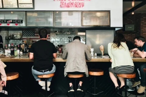 People sit at the bar for a burger restaurant