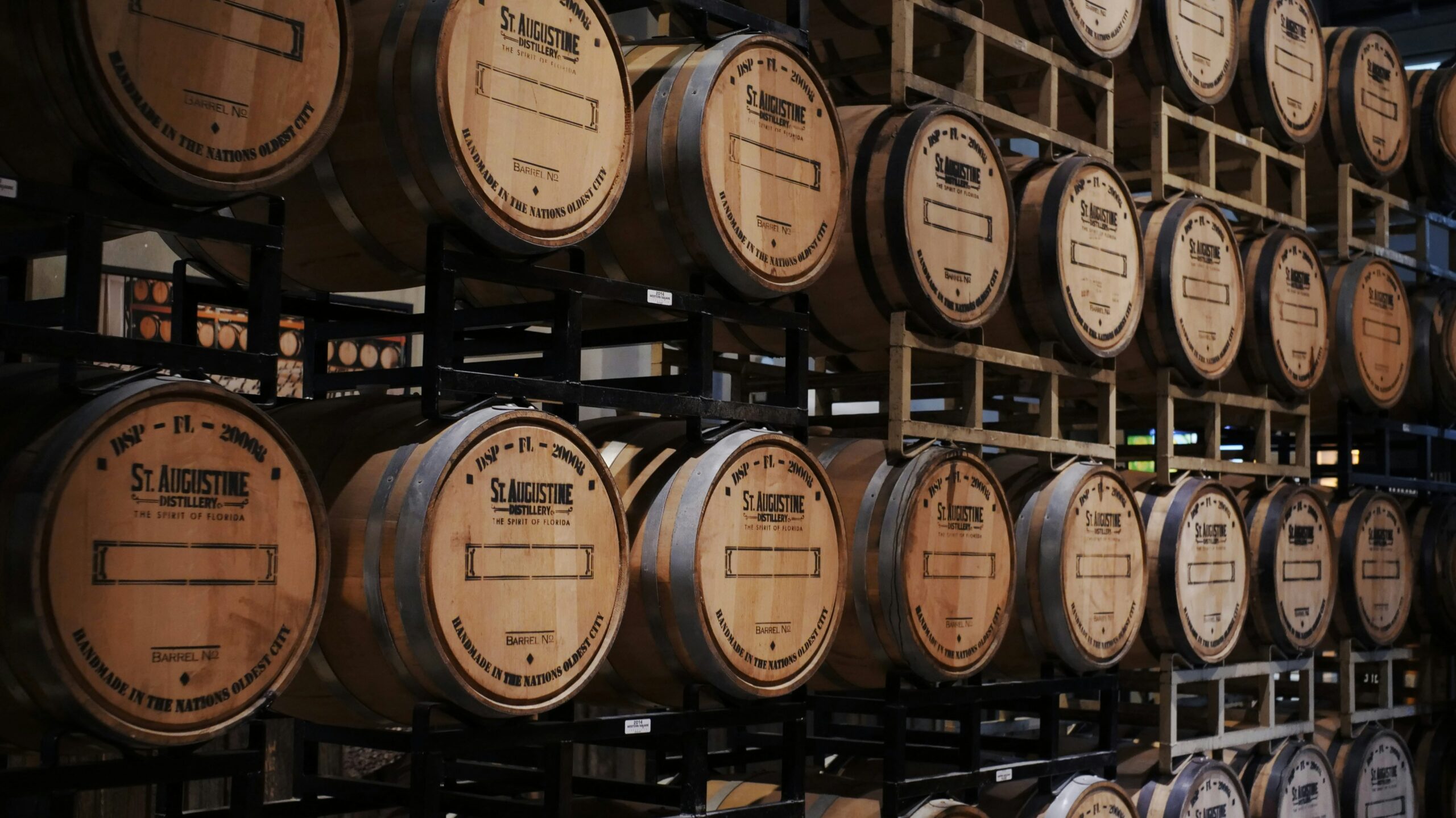 Brown wooden barrels stored on rack at St Augustine Distillery.