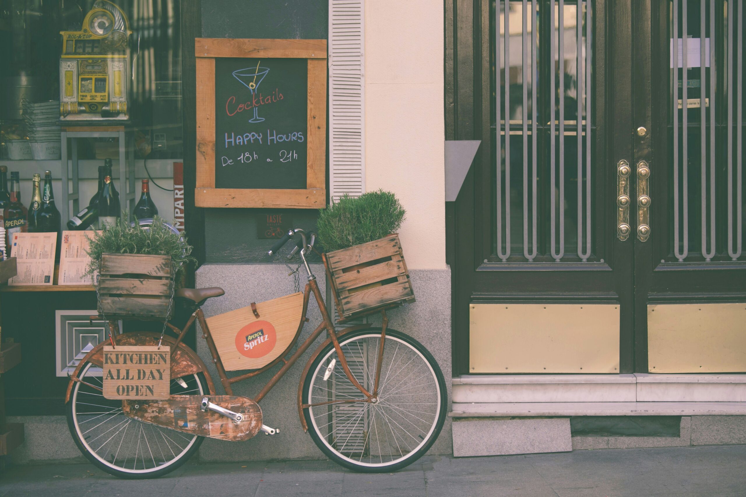 Bike outside a bar beneath a sign advertising Happy Hour