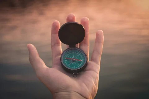 Hand holding compass