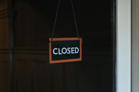 Closed sign in a dark window